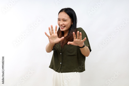 Young asian woman disgusted expression, displeased and fearful doing disgust face because aversion reaction. with hands raised