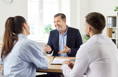 Husband and wife, clients hold a briefing with a financial agent or real estate consultant as clients. The meeting focuses on investment strategies and property decisions for future plans.