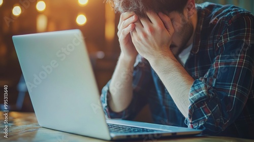 a person looking disappointed while reading a rejection email on a laptop.