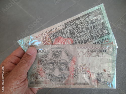 Indonesian rupiah banknotes issued in 1975 with a nominal value of ten thousand rupiah 