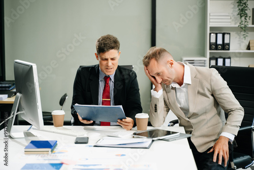 Furious two businesspeople arguing strongly after making a mistake at work