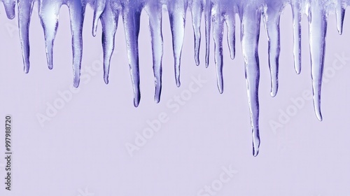 Icy stalactites hang against a pale purple backdrop in winter