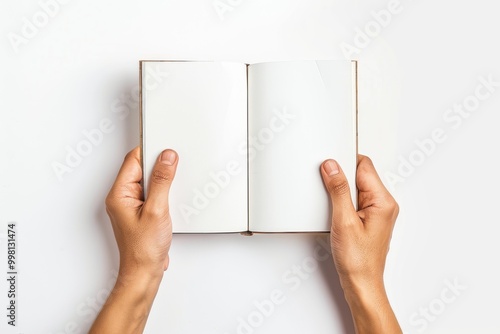 Hands holding an open blank book on a white background. Minimalistic mockup for book design.