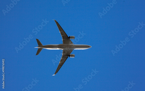 Commercial Airplane Ascending Against Clear Blue Sky - Modern Air Travel and Transportation