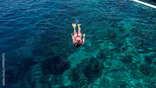 Gili Islands Tourism. Snorkeling from a trimaran off the coast of Gili Air Island with the clearest water