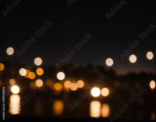 Bright glowing lights of district in megapolis under dusk sky in evening on blurred background