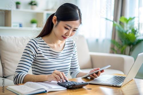 asian young woman hand using calculator to calculating money balance from bill and income