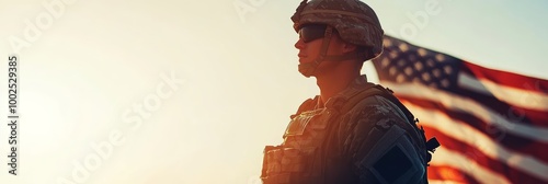 Silhouette of a US soldier against the sunset and flag, Veterans and Memorial Day celebration.