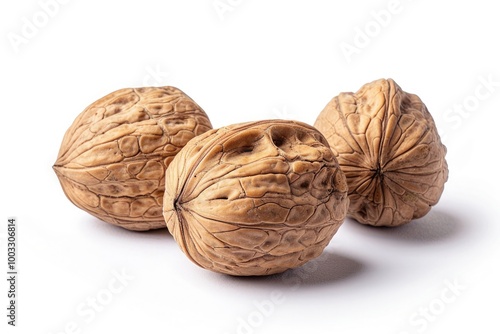 Three walnuts isolated on a white background with detailed texture and natural brown color