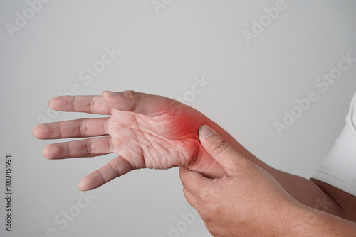 Male person with inflammation on hand wrist area, stiffness and pain in thumb, de quervain syndrome, tenosynovitis, arthritis, tendonitis disease