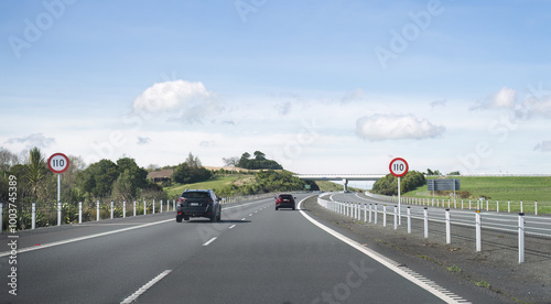 Driving on Waikato Expressway. 110 km/h road speed sign on the road side. New Zealand.