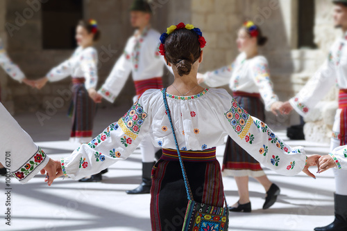 Dancers dancing and wearing one of the traditional folk costume from Romania