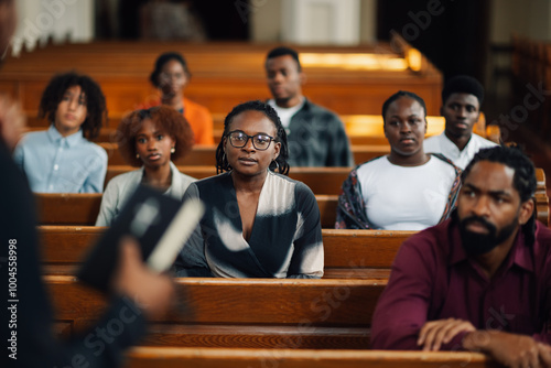 Group of people sitting in church pews listening to sermon