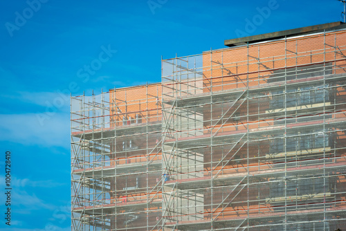 Scaffold sheeting net wrapped apartments building during insulation in england uk