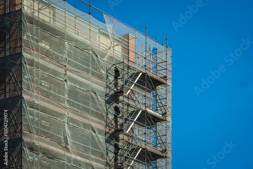 Scaffold sheeting net wrapped apartments building during insulation in england uk