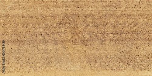 view from above on texture of dry muddy road with tractor tire tracks in countryside