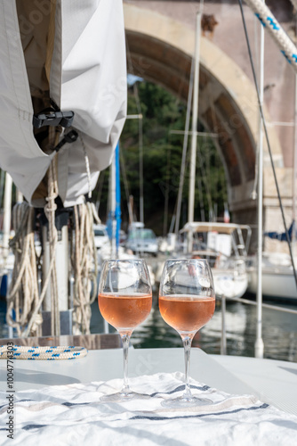 Party with rose wine on yacht boat anchored in port la Rague, Gulf of La Napoule, in Provence, two glasses of cold rose wine, French Riviera near Cannes, south of France