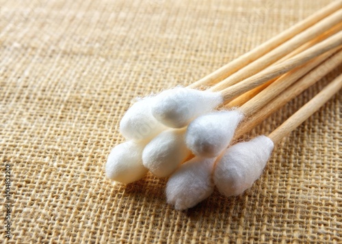 Close-up of a cotton swab on a soft fabric background for hygiene and beauty concepts and products