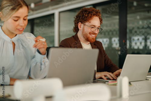 Two dedicated professionals are engaged in a highly productive and innovative collaboration at a sleek office workspace