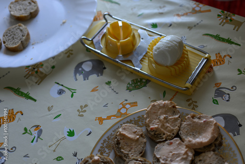 Chopped eggs in a slicer on the table. 