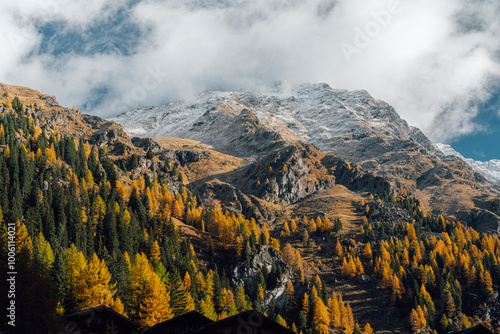 Stunning autumn mountain scenery in the Alps with golden larches in fall