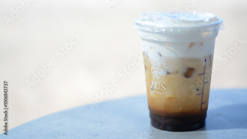 Langkawi, Malaysia: Oktober 2nd, 2024 : The ZUS Coffee logo is prominently displayed on the side of the cup, indicating the brand.