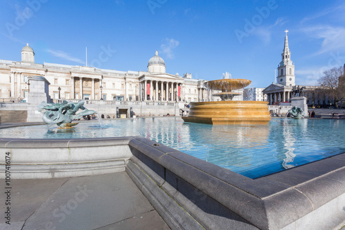 Fountain on Trafalgar square with National Gallery at background, London