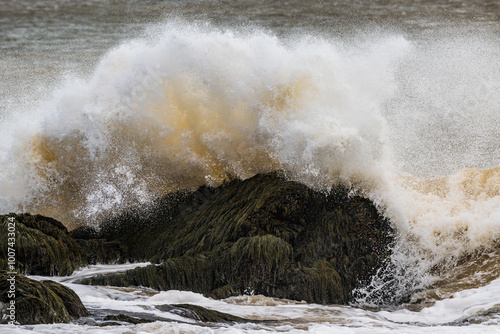 Large ocean wave crashing over rocks