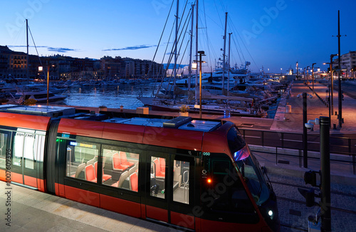 Nice, Provence-Alpes-Cote d'Azur, France - March 2, 2020: Dawn view of a tram and yachts at the port