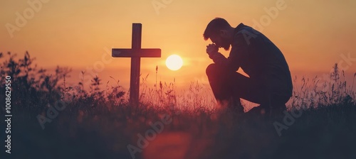 Man Kneeling in Prayer at Wooden Cross with Dramatic Sunset, Faith and Spirituality Concept.