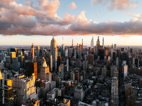 An aerial photo of Manhattan's upper downtown from above during the sunrise clouds in the background. New York, USA