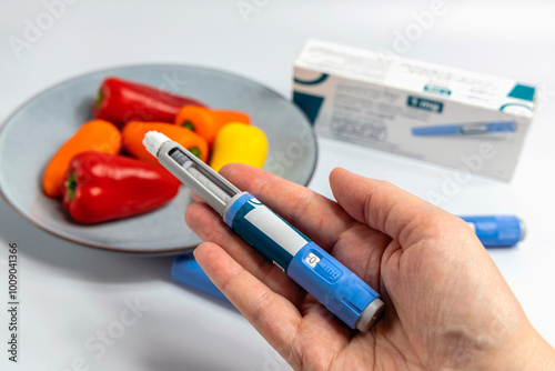 Hands holding Ozempic Insulin injection pen for diabetics and weight loss