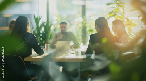 Team of business professionals is having a productive meeting in a modern office filled with natural light and lush green plants, fostering a positive and eco-conscious work environment