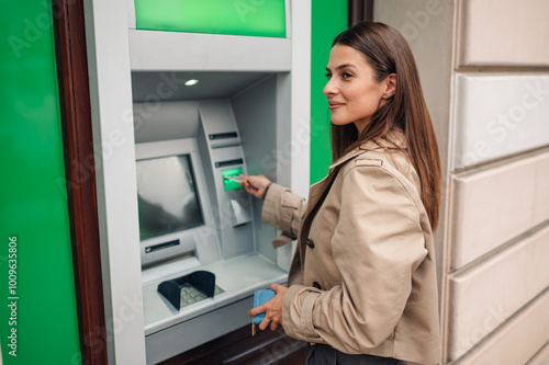 Young woman withdrawing money from atm