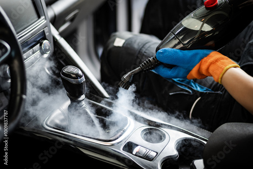 Steam cleaning a car interior to remove dirt and grime in a detailed auto detailing session