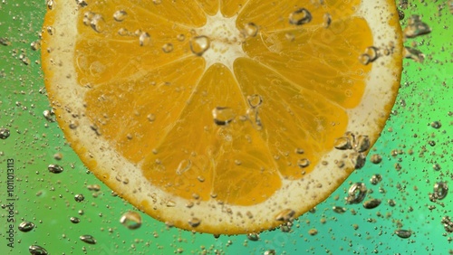 Macro Shot of Fresh Orange Slice in Water with Air Bubbles