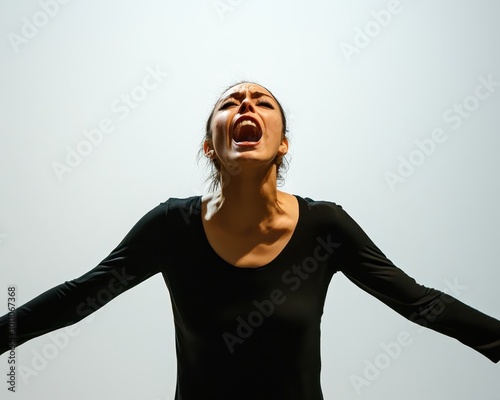 Woman acting out a dramatic scene, her face expressing intense emotion, minimalistic stage background, powerful performance, acting, emotions