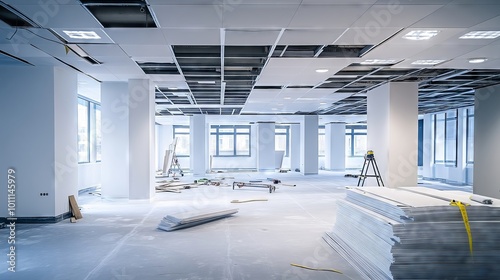 Suspended ceiling grid and ceiling tiles being installed in modern office building