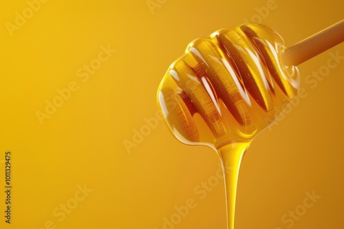 Dripping honey from a wooden dipper against a warm yellow background