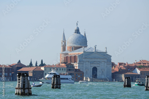 Venice, Veneto, Italy. October 24, 2010: Canal view of Venetian church with boats in Venice, Italy.