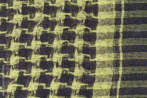 Checkered yellow black keffiyeh, fragment top view close-up