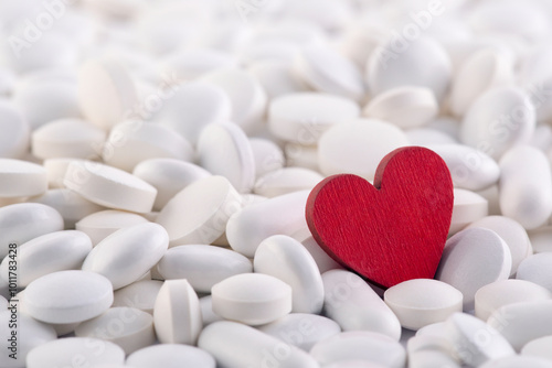 Red heart on heap of many various medicine pills