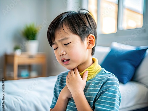 Asian child suffering from a sore throat, holding their neck in discomfort at home or clinic setting