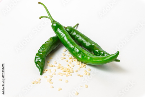 Fresh serrano pepper (Capsicum annuum 'Serrano') on isolated white background with pepper seeds itself (Cabai Serrano di latar belakang warna putih beserta bijinya)