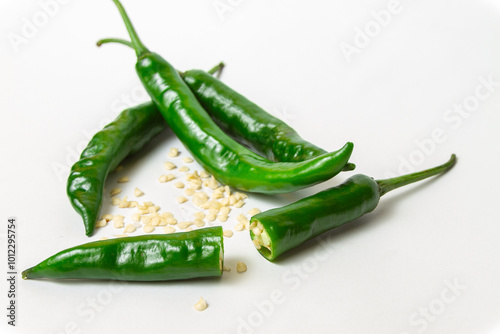 Fresh serrano pepper (Capsicum annuum 'Serrano') on isolated white background with pepper seeds itself (Cabai Serrano di latar belakang warna putih beserta bijinya)