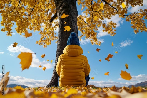 Person sitting under a tree in the park, surrounded by falling leaves, remembering the important moments of yesterdayâ€™s events