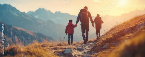 A family hiking together in the mountains during sunset, enjoying nature and creating lasting memories on their adventure.