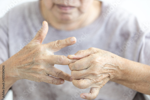 Senior woman with Trigger finger disease,pain in hand,elderly massaging,rubbing and kneading of muscles and joints,stretch the tendons in fingers,exercise her hand,therapy,health care,medical concept