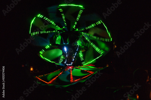 Performance of a young artist, evening light show on the Safaga stage, Egypt July 2022, Long exposure time. Dervish Dance