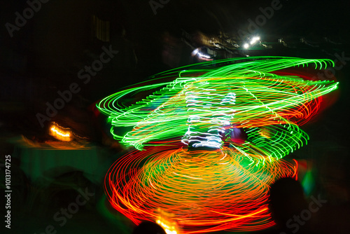 Performance of a young artist, evening light show on the Safaga stage, Egypt July 2022, Long exposure time. Dervish Dance